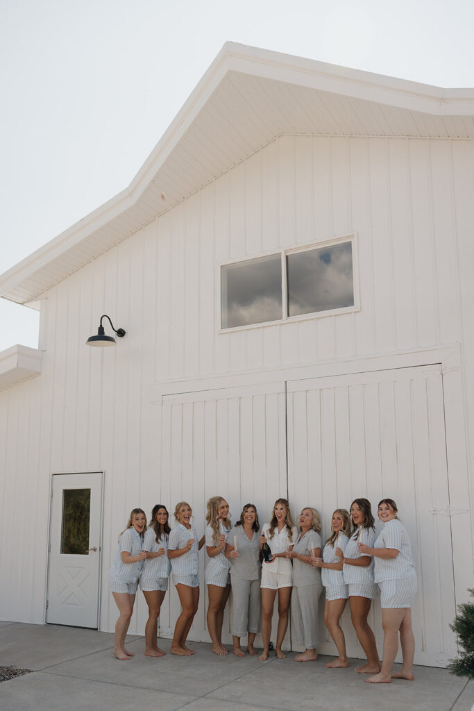 bridesmaids getting ready and popping champagne the morning of a wedding