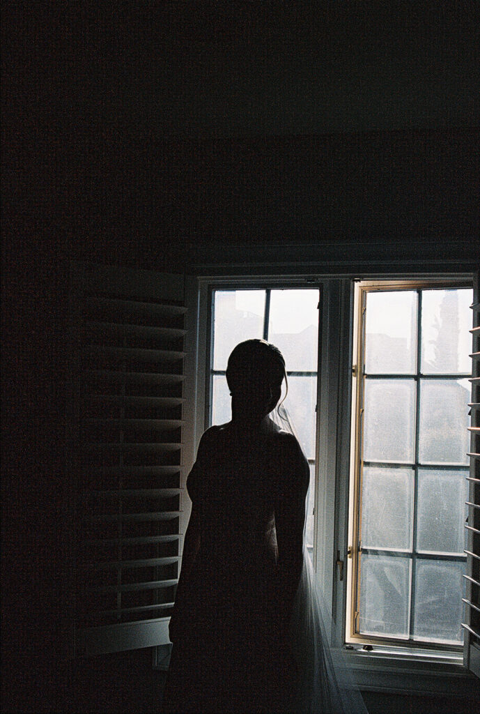 bride getting ready in front of window