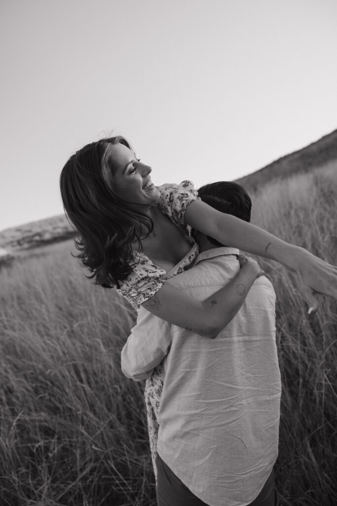 couple dancing in open field in fort collins during their colorado engagement