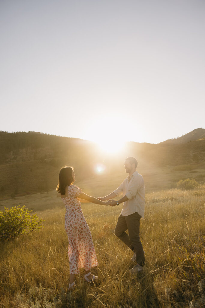 couple dancing in open field in fort collins during their colorado engagement