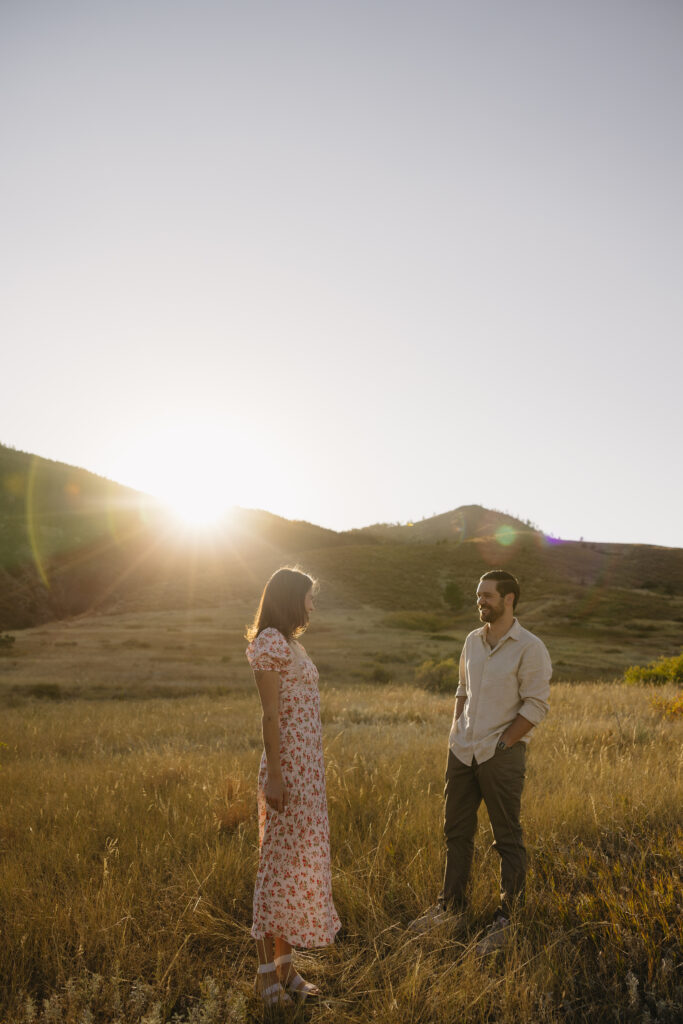 couple standing in open field in fort collins during their colorado engagement