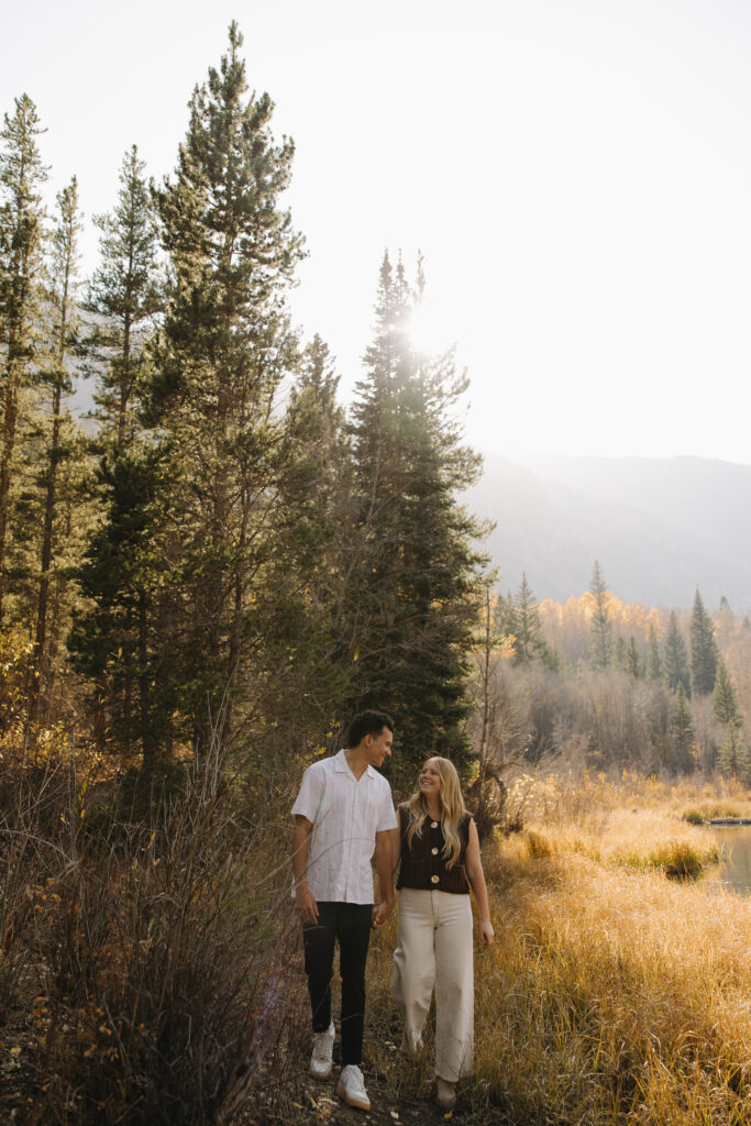 couple walking with each other during their colorado engagement photos at aspen