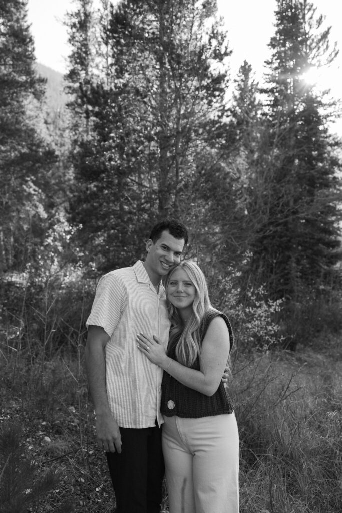 couple holding onto each other during their colorado engagement photos at aspen