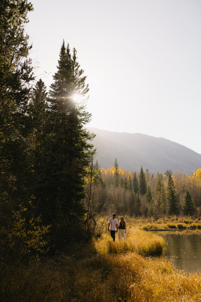 couple walking with each other during their colorado engagement photos at aspen