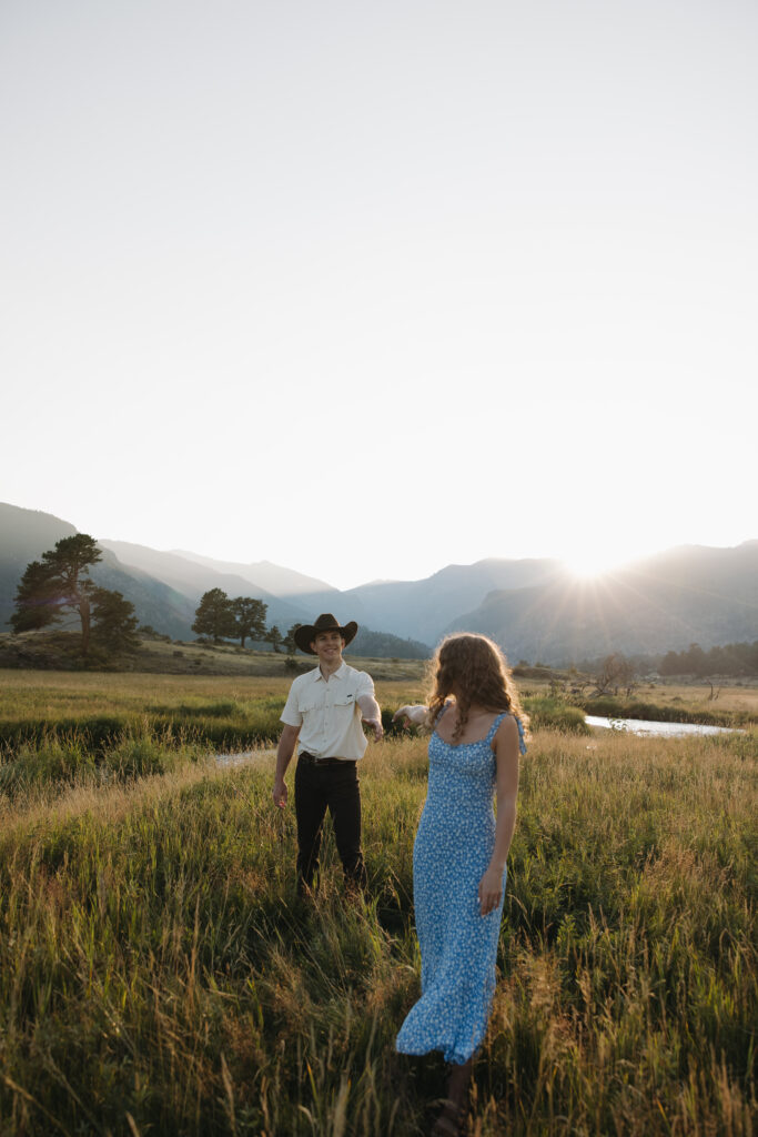 couple dancing in open field at rocky mountain national park during their colorado engagement