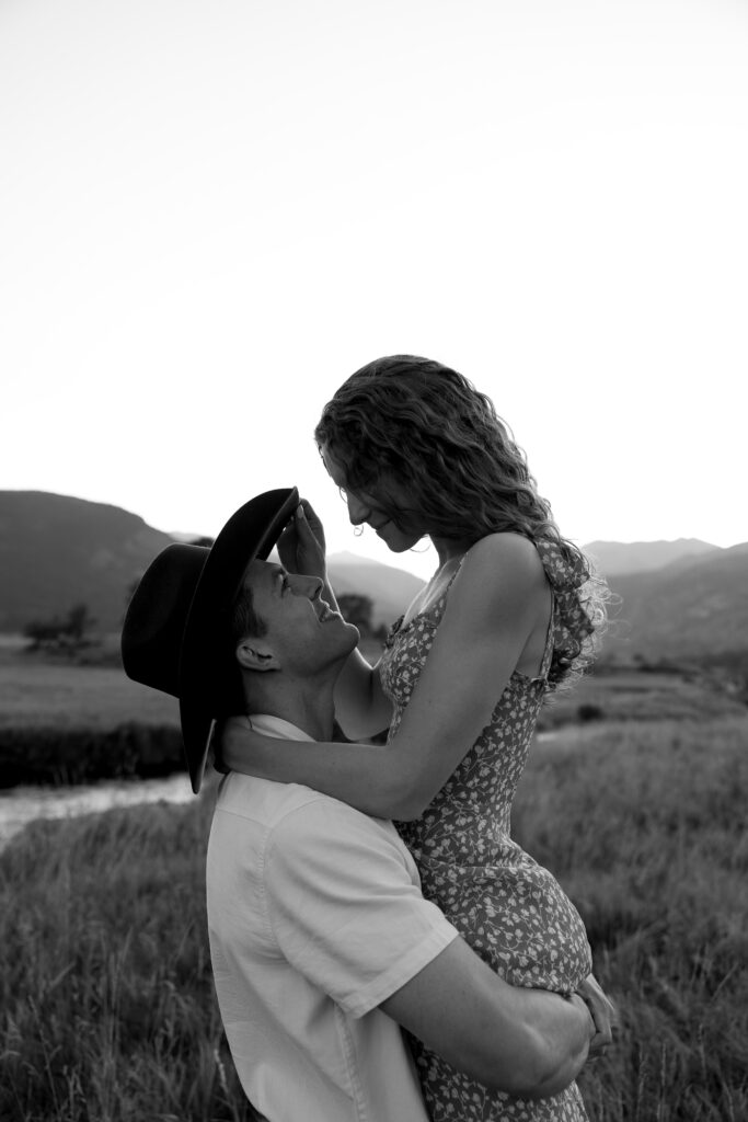 couple dancing and hugging in open field at rocky mountain national park during their colorado engagement