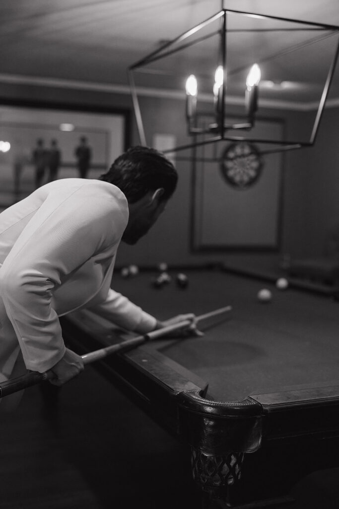 groom playing pool during getting ready moments