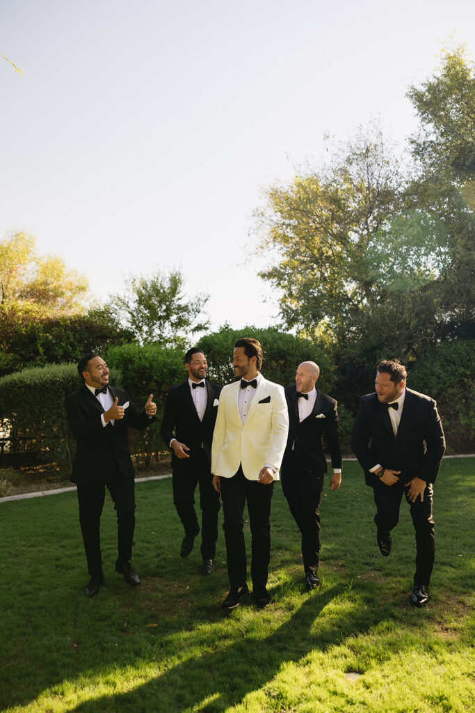 A luxe timeless wedding day in Scottsdale Arizona wedding with groom having fun with his groomsmen