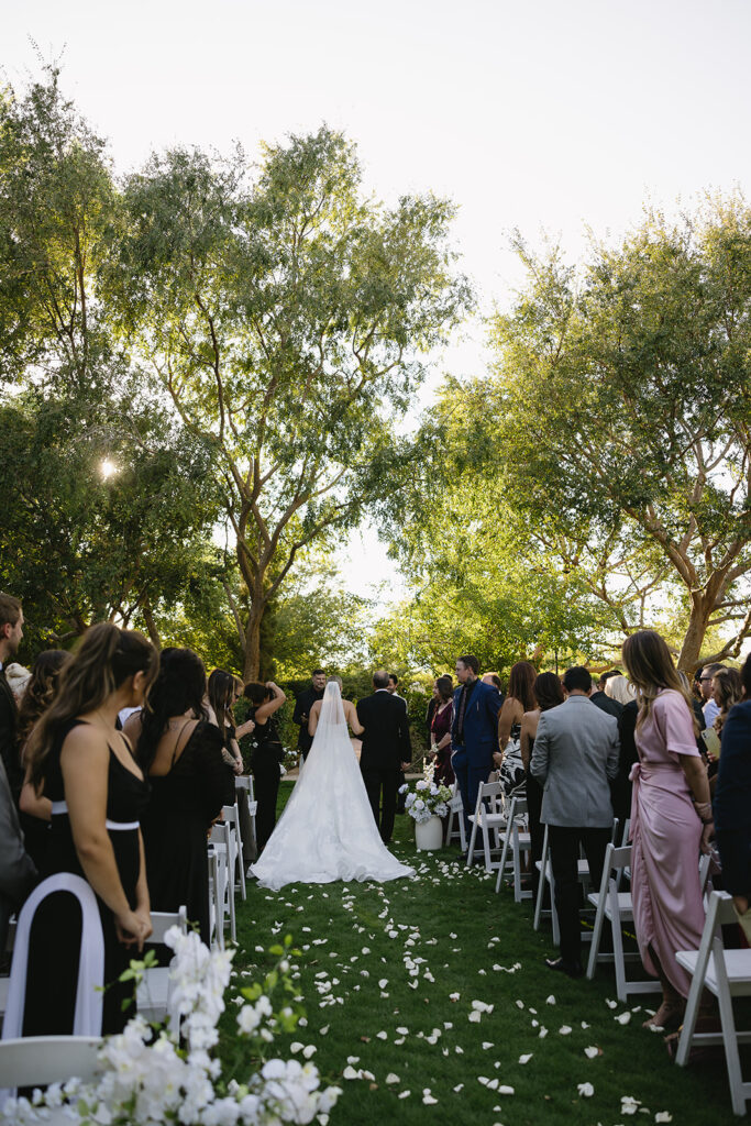 bride standing at ceremony altar with dad 