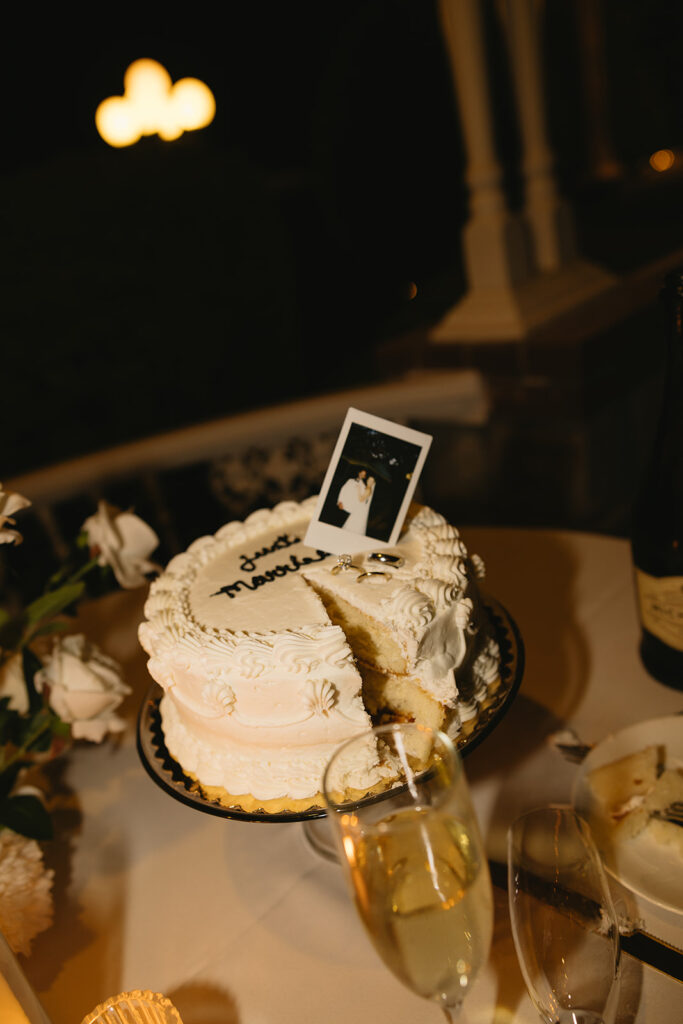 wedding cake with polaroid sticking out of the top of cake