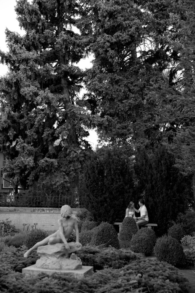 couple sitting on bench in front of the garden  at denver botanical gardens 