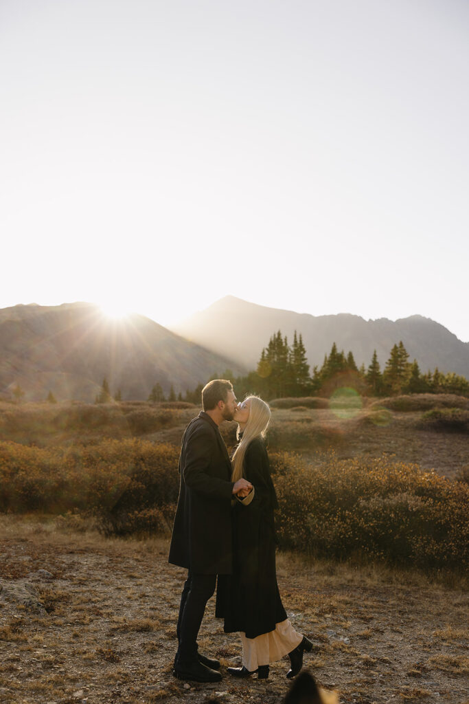 couple kissing during their colorado engagement photos at loveland pass