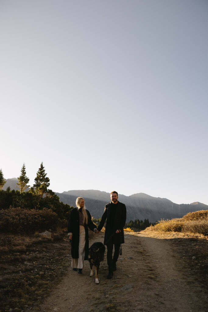 couple walking with each other during their colorado engagement photos at loveland pass