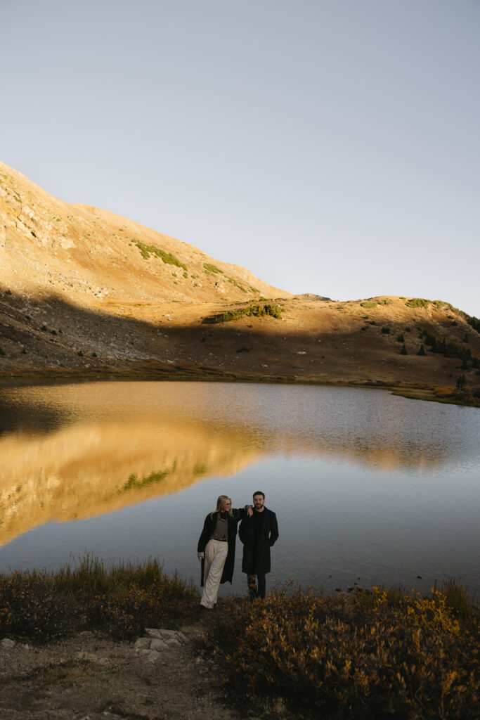 couple posing with each other during their colorado engagement photos at loveland pass