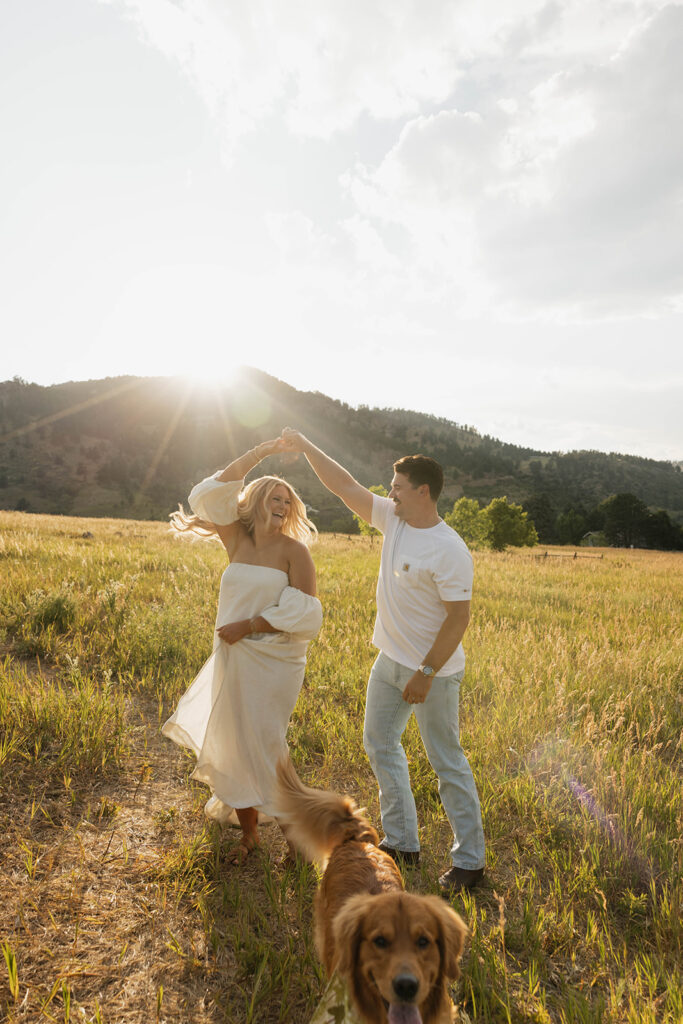 couple dancing in open field at boulder during their colorado engagement