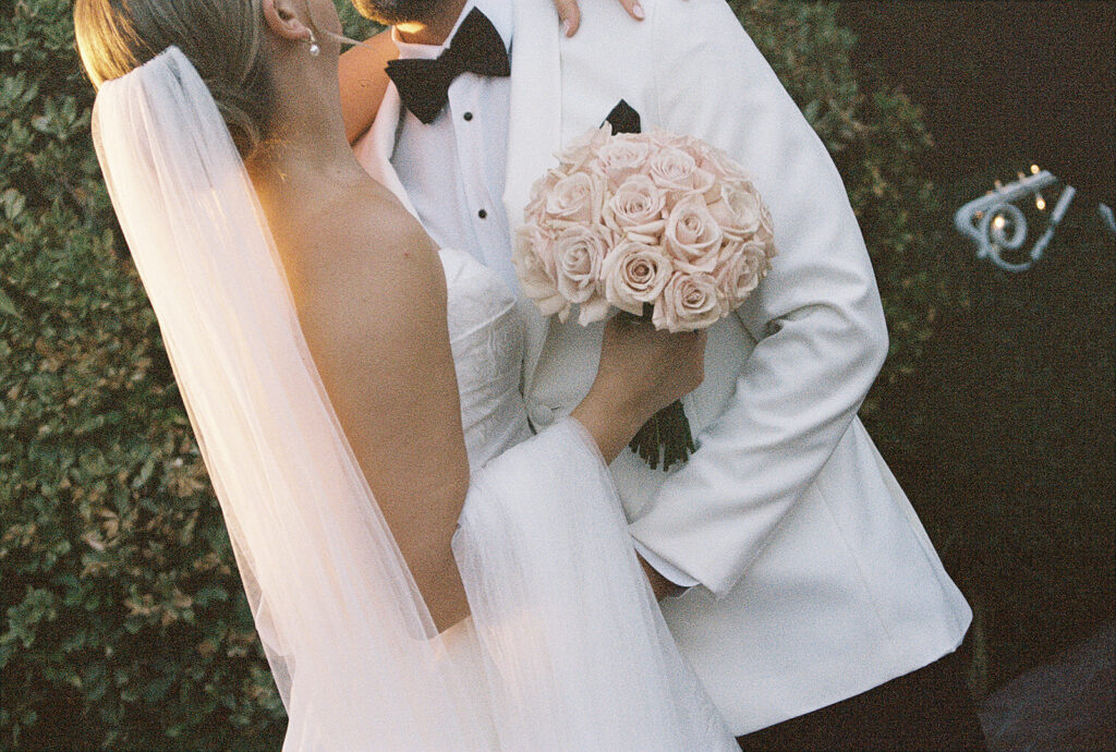 bride and groom kissing during wedding photos