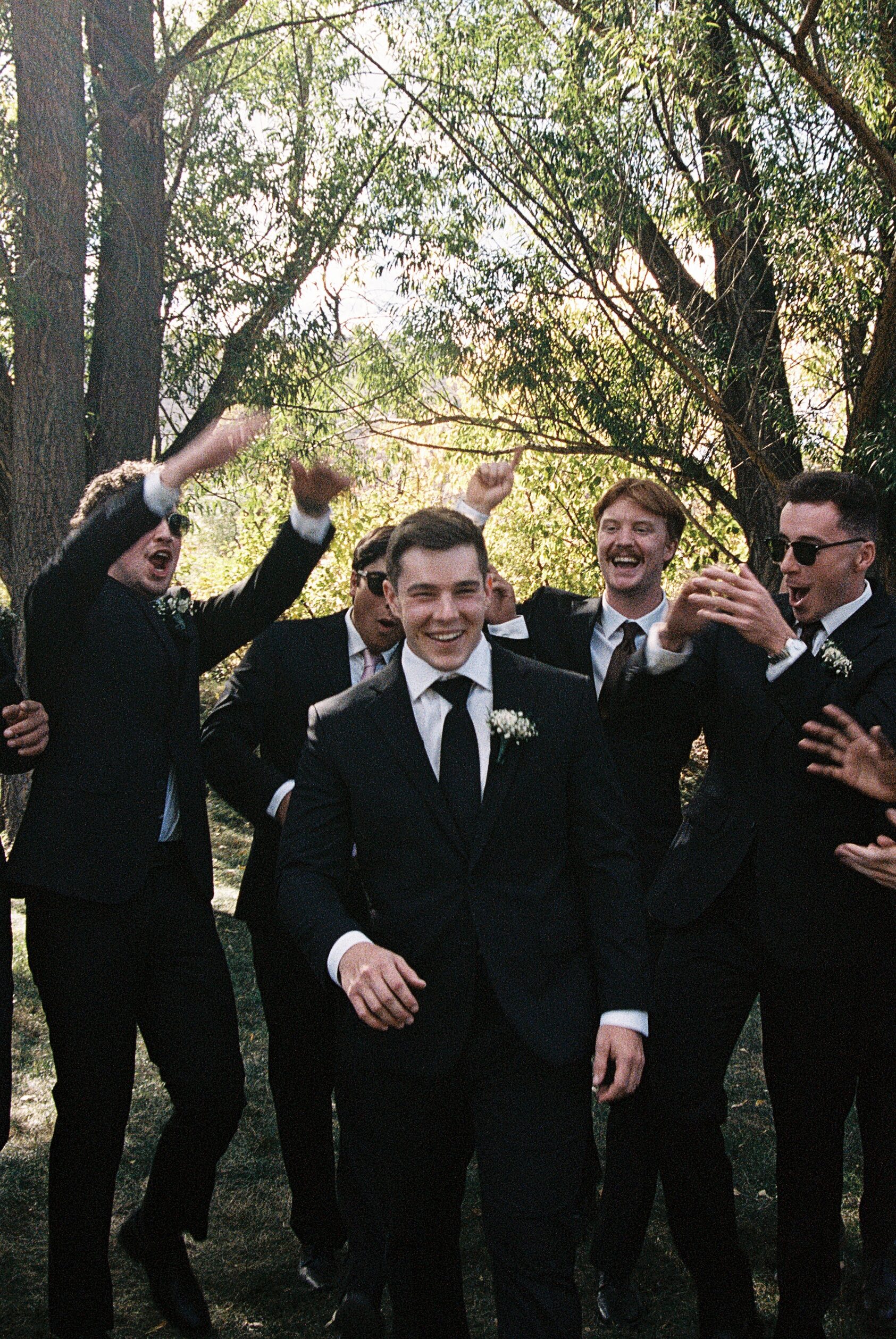 groom and groomsmen having fun captured on film photography