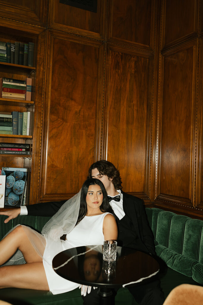 groom kissing brides temple at a bar