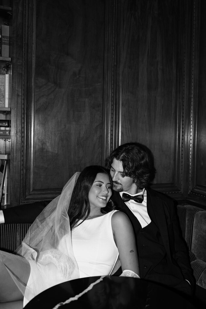 black and white photo of bride and groom sharing a moment after their wedding day