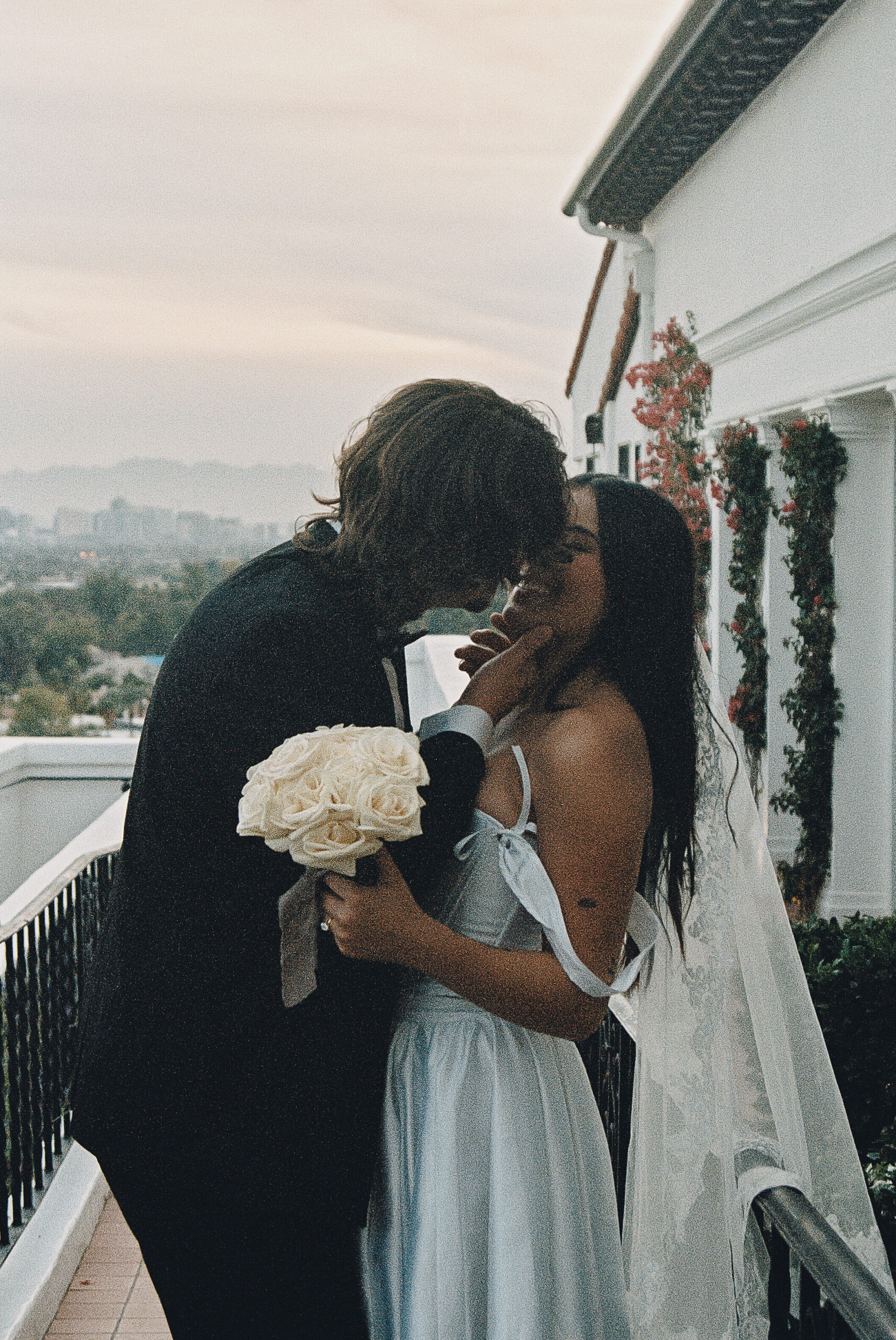 film photo of bride and groom kissing at their luxury wedding venue