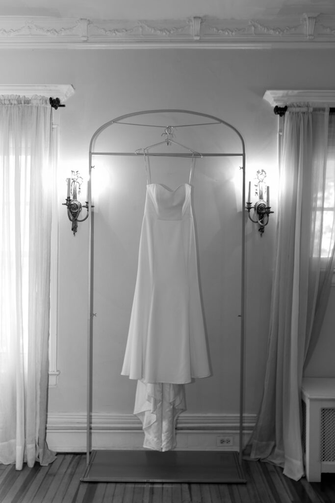 photo of wedding dress hanging during wedding detail photos