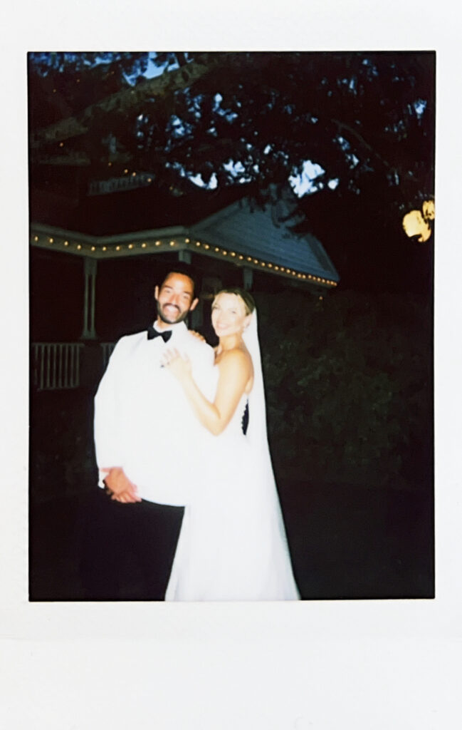 photo of bride and groom holding each other through film photography as a polaroid