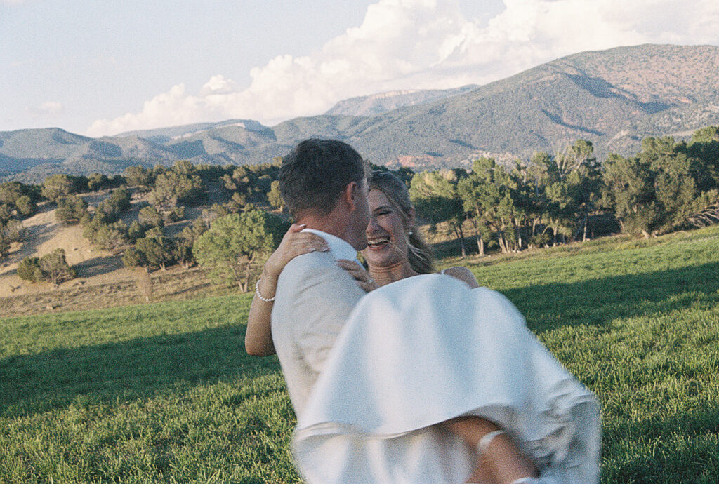 groom holding bride during wedding photos captured on film photography