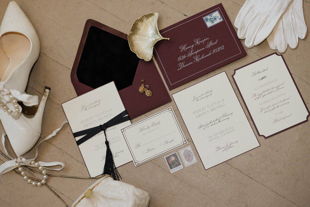 photo of wedding flatlay with invitation suite, wedding shoes and wedding gloves