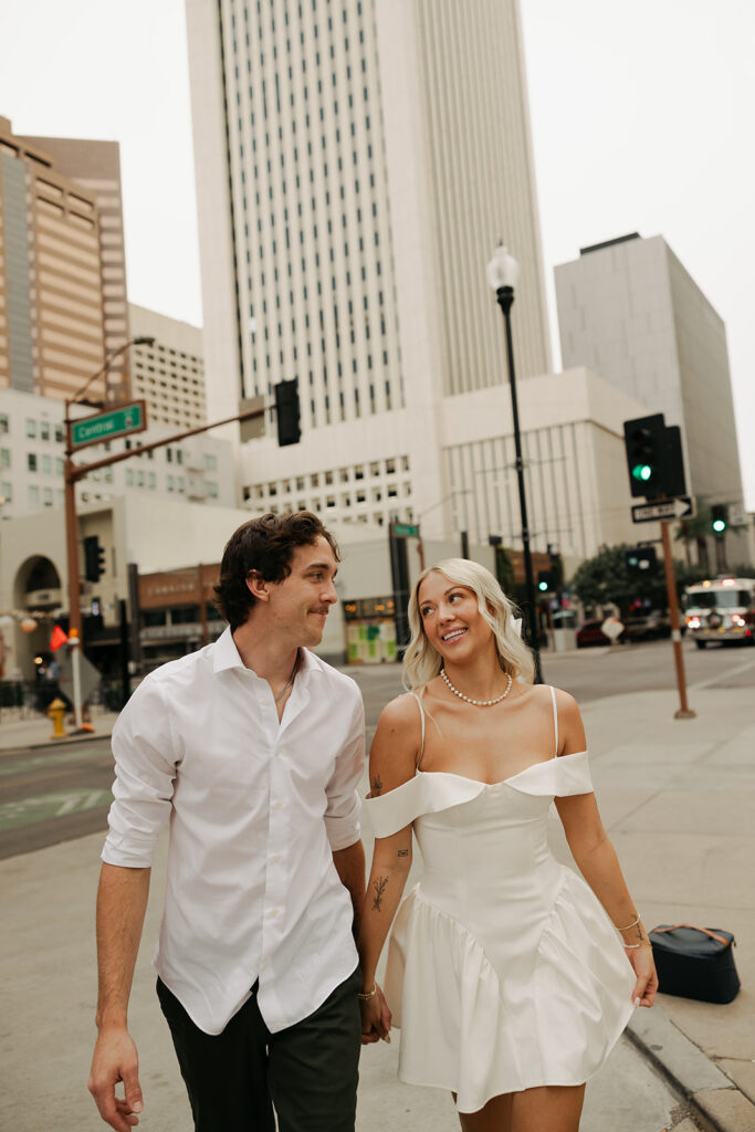 couple holding hands during downtown phoenix engagement photos 