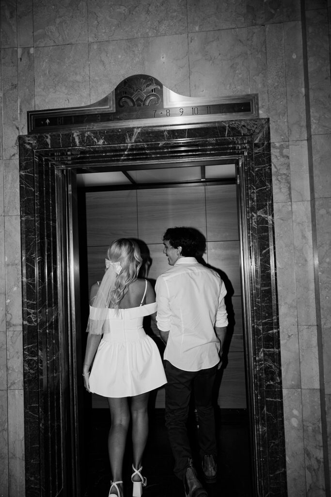 couple walking into elevator during couples session