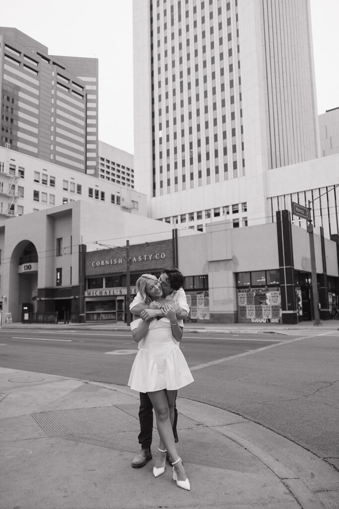 couple holding each other during downtown phoenix engagement photos 