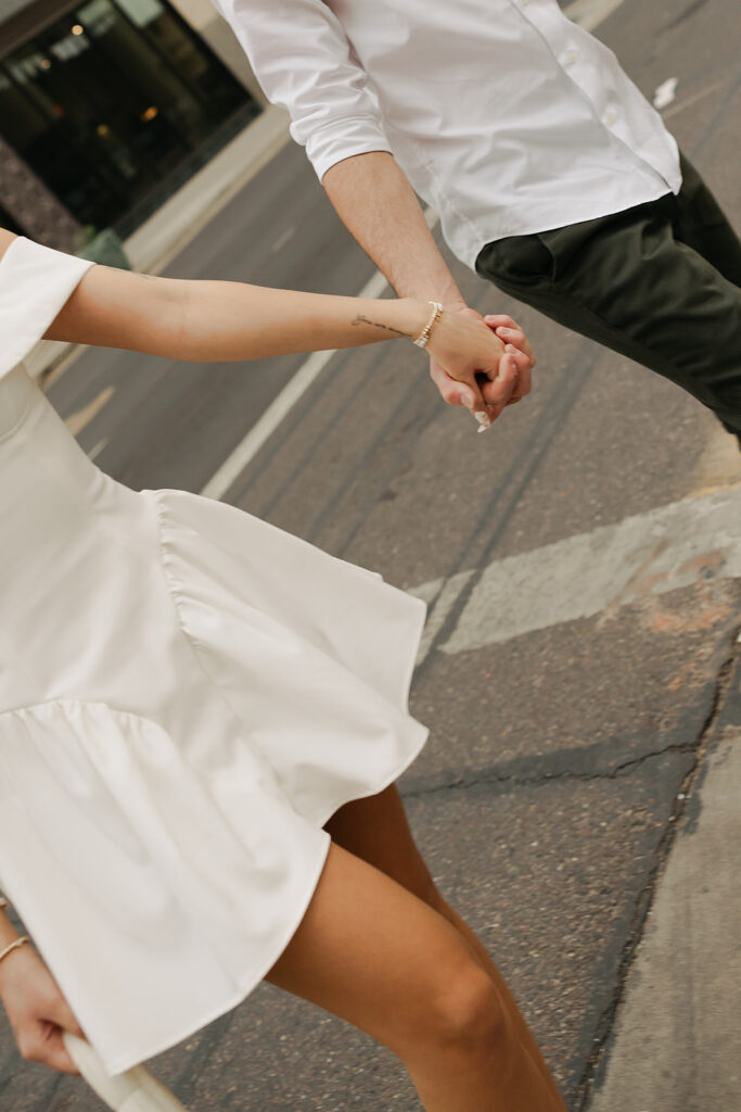 couple holding hands during downtown phoenix engagement photos 