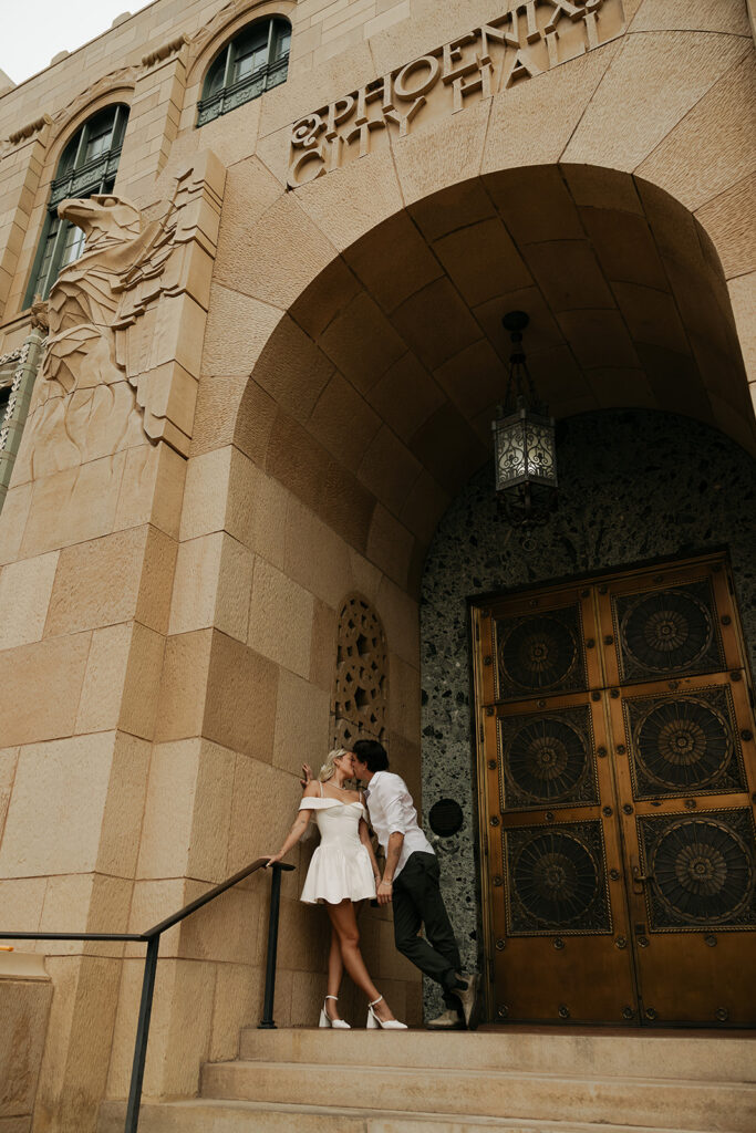 couple kissing during downtown phoenix engagement photos 