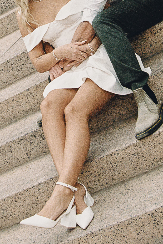 film photo of couple sitting on steps during engagement session