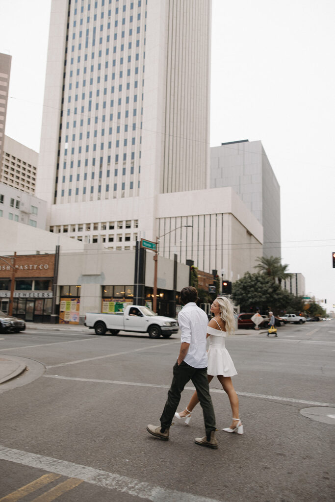 couple wallking during downtown phoenix engagement photos 