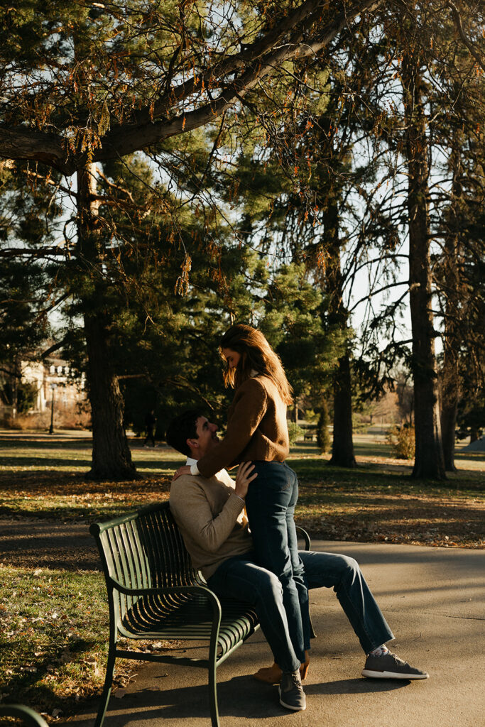 couple sitting in park during colorado engagement photos