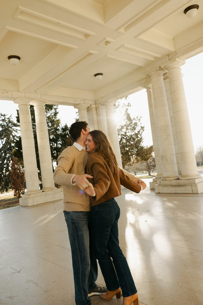 couple dancing at cheesman park in denver during their colorado engagement photos