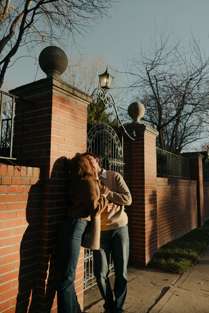 couple kissing at cheesman park in denver during their colorado engagement photos