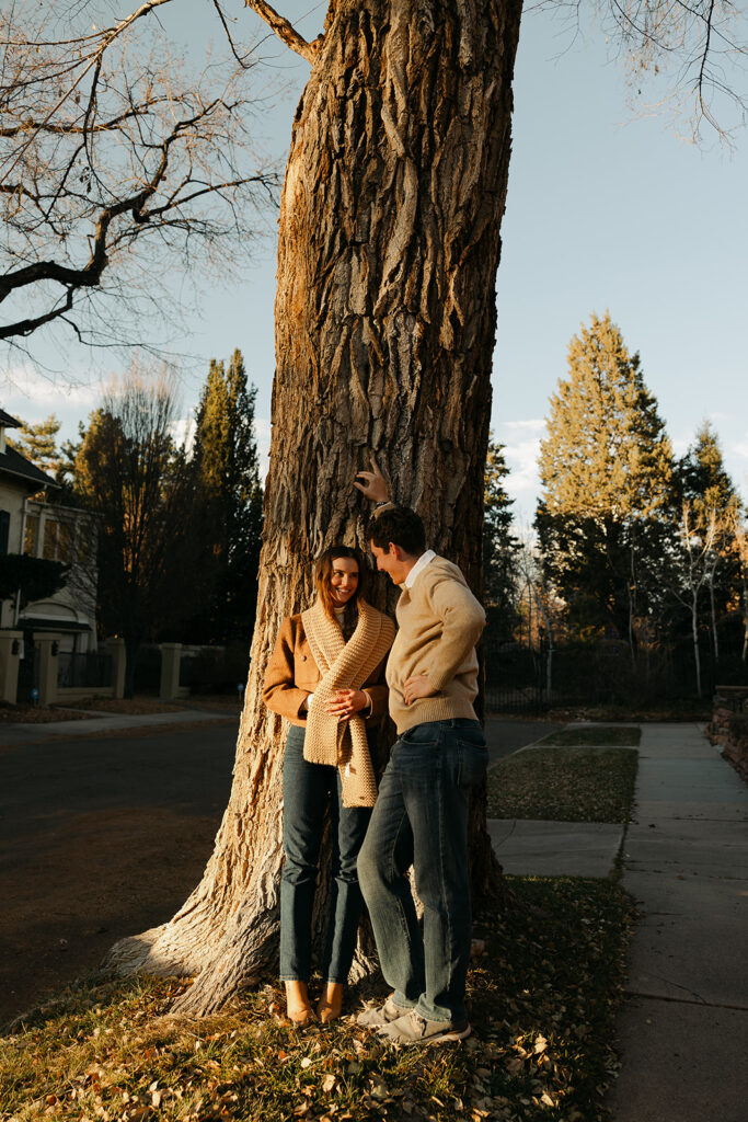 couple leaning against tree at cheesman park in denver