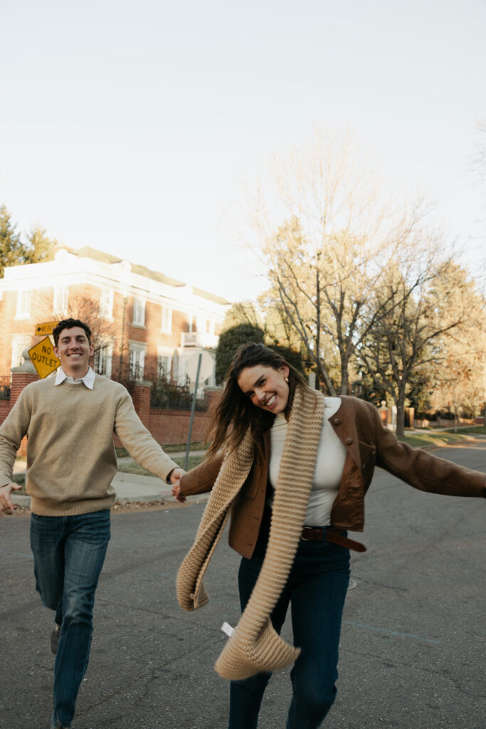 couple dancing in the road during colorado engagement photos