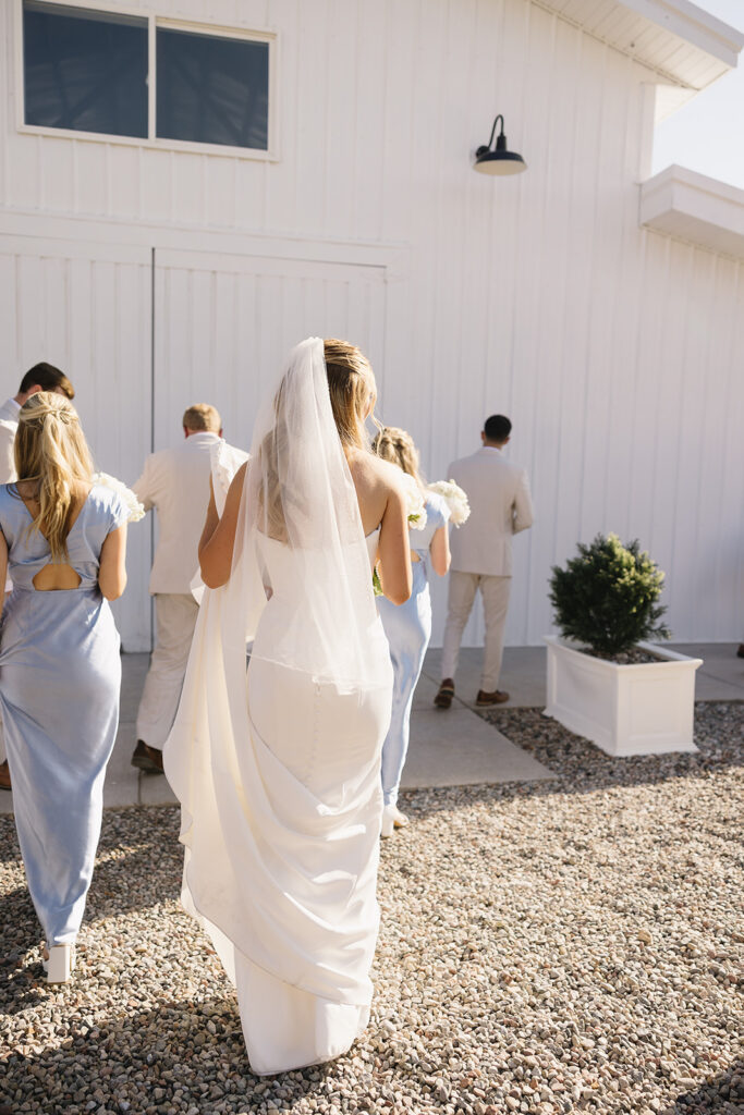 bride walking into the white barn at vista view events