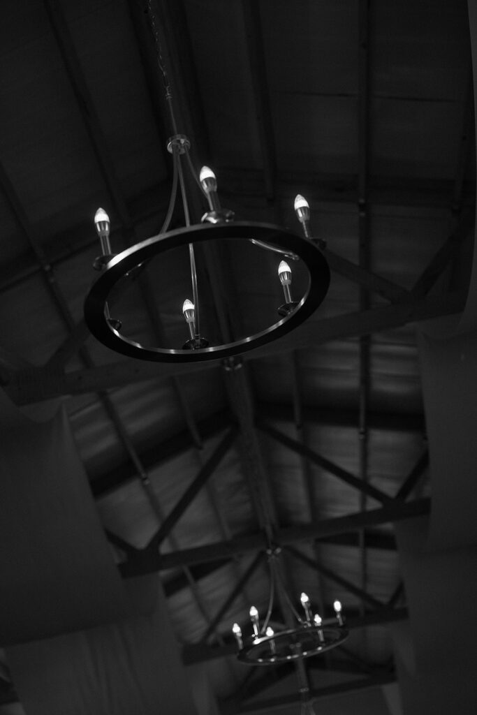 detail photo of reception space candle chandeliers