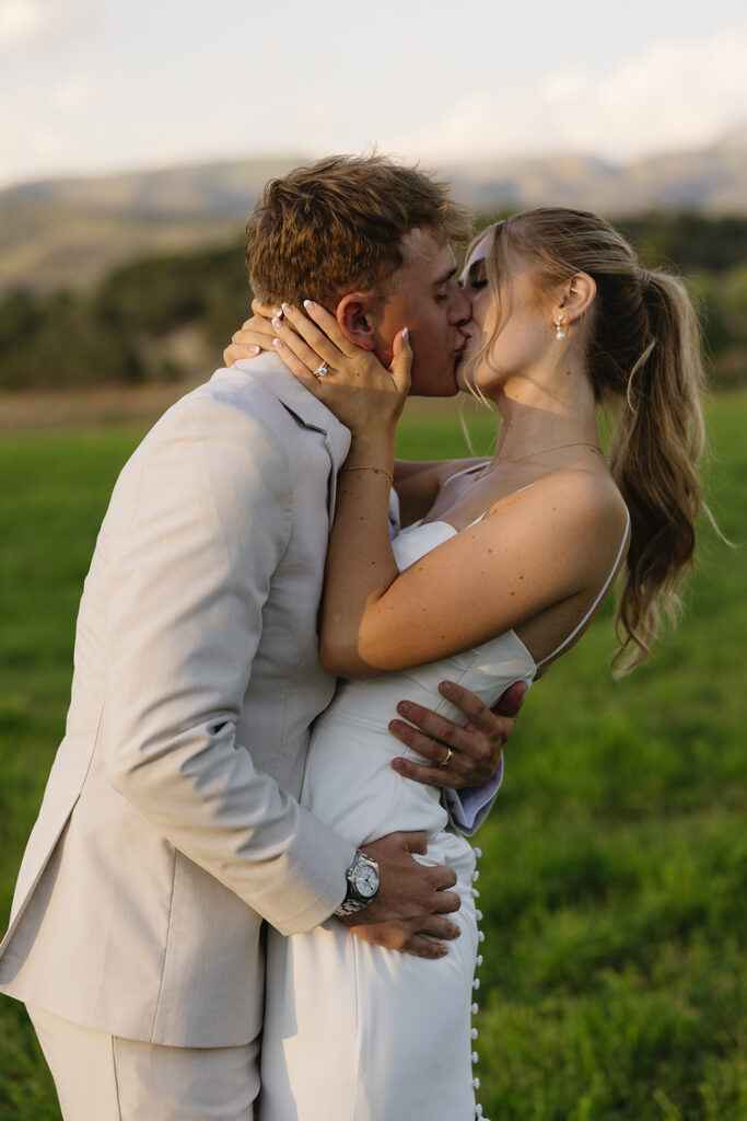 bride and groom portraits on wedding day kissings