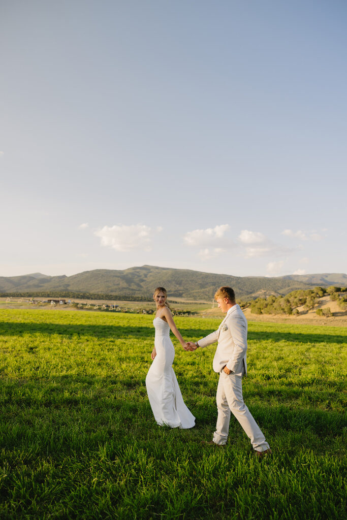 bride leading groom on their wedding day during couples photos