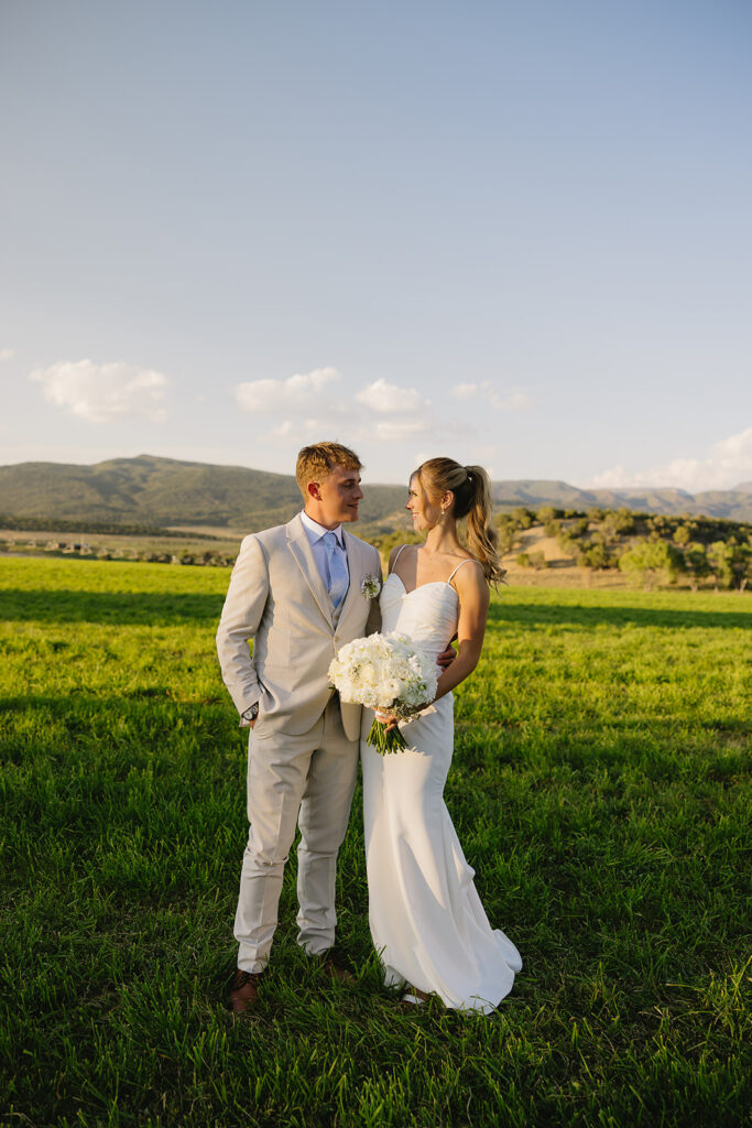 bride and groom portraits on wedding day holding flowers