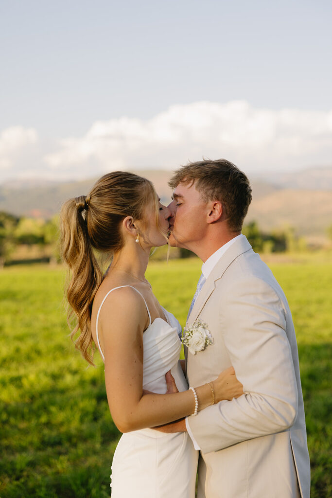 portrait of the newlyweds kissing 