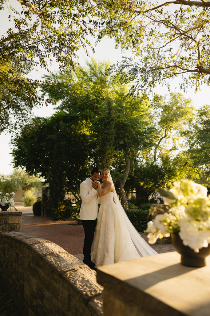 portrait of the groom kissing the bride on the hand