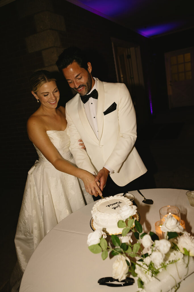 portrait of the newlyweds cutting their wedding cake