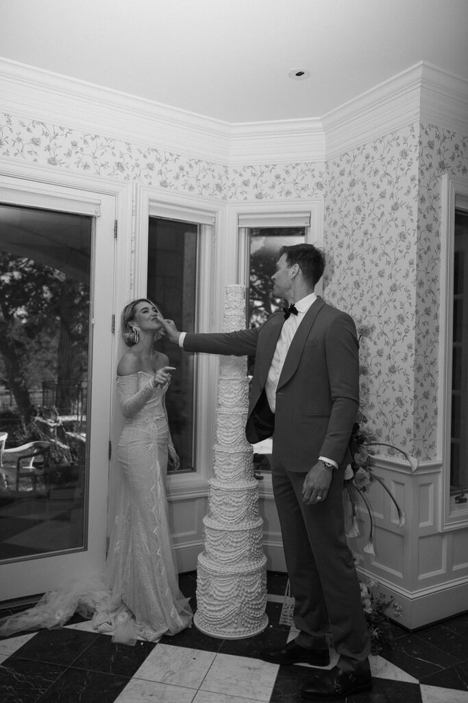 bride and groom eating their wedding cake together at greystone castle boulder