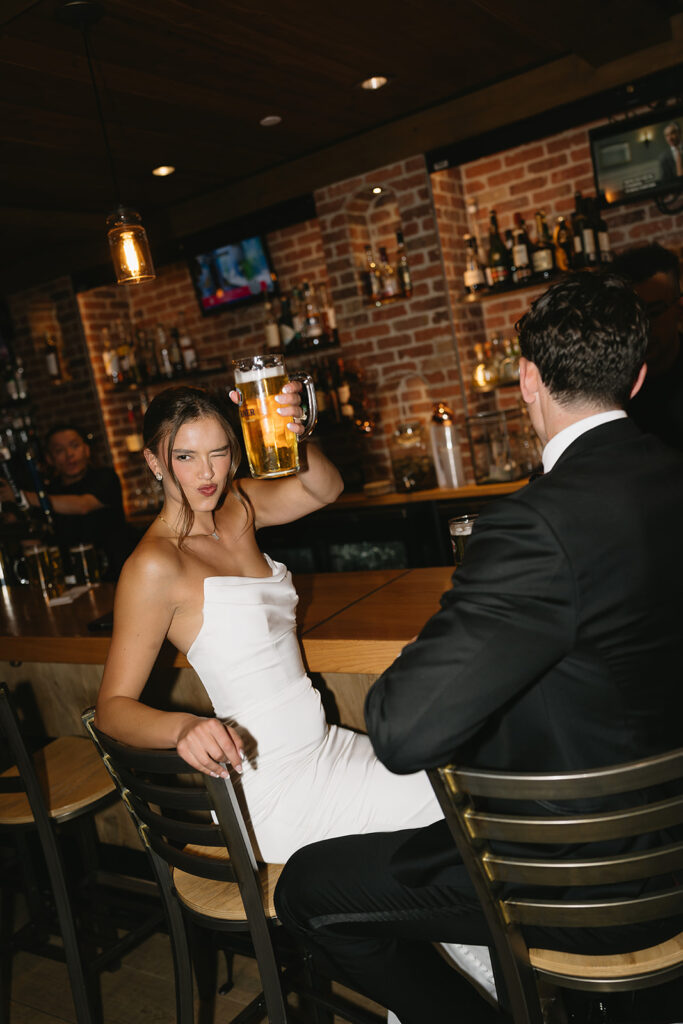 candid bride and groom photos drinking beer
